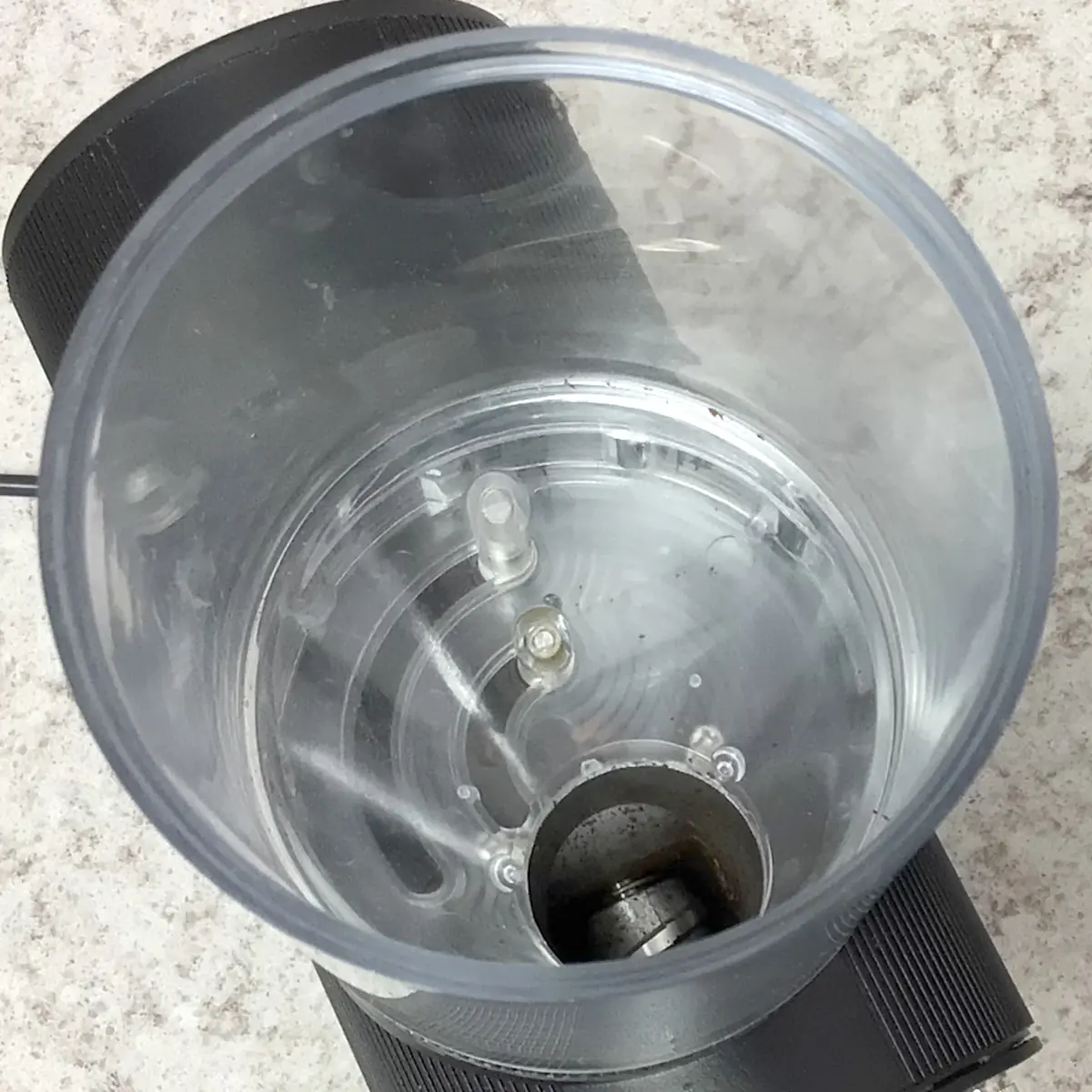 A SIDEWALK SALE Pinecone Pinion All-Purpose Espresso Coffee Grinder (showroom demo) in black with a clear plastic container. © 2025 1st-line.com