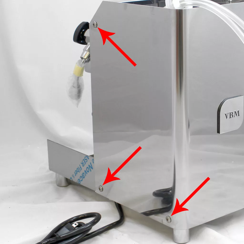 Close-up of a shiny metal appliance with three red arrows pointing to screws on a side panel, suggesting areas for removal or maintenance. A black power cord and part of a plastic tube are also visible. © 2025 1st-line.com