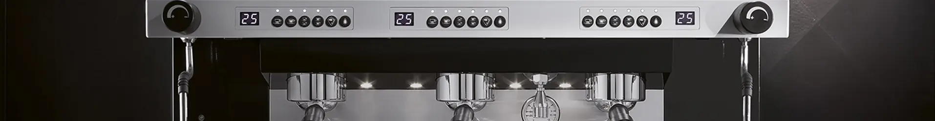 Close-up of a modern commercial espresso machine with multiple group heads, button controls, digital displays, and portafilters in place, set against a dark background. © 2025 1st-line.com