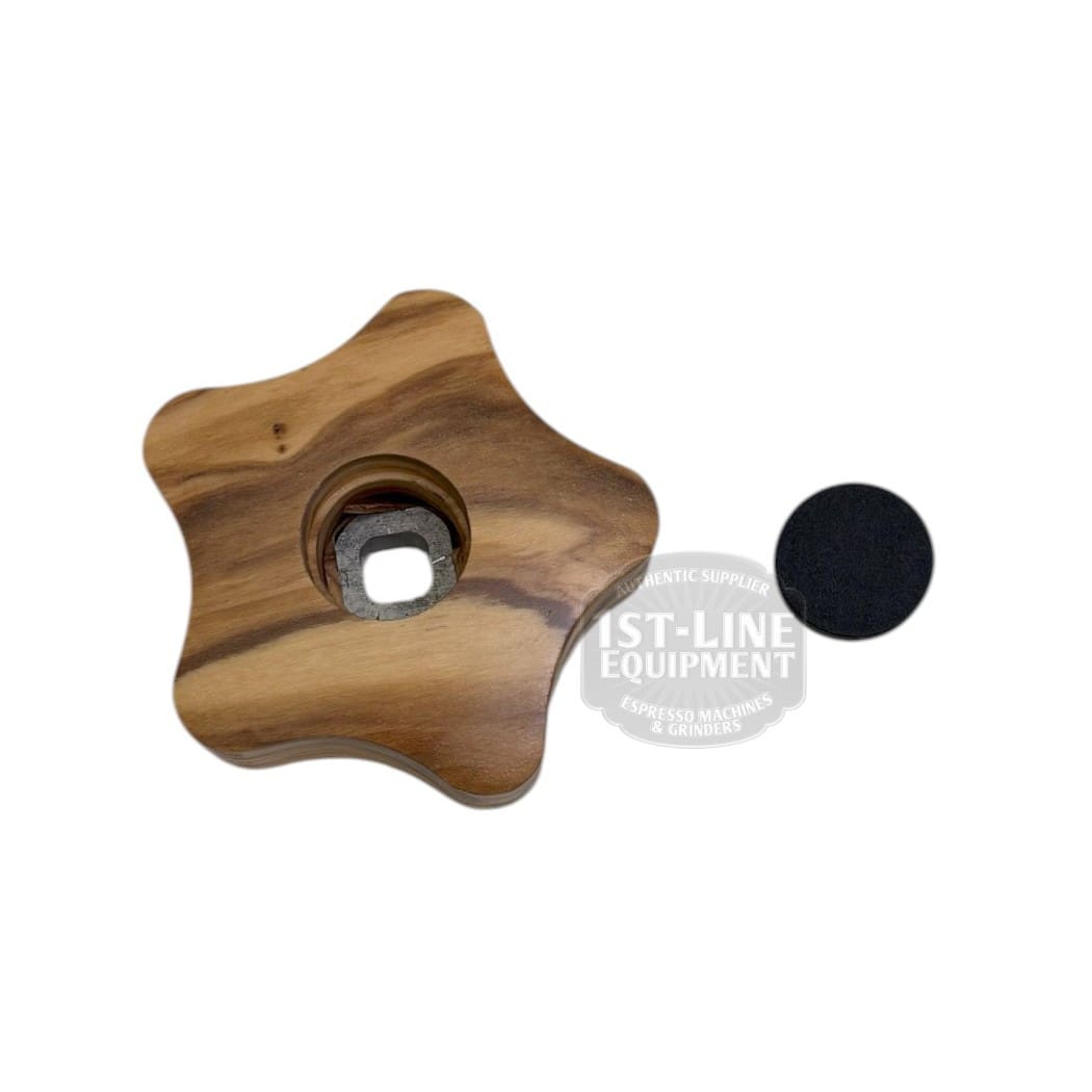 The ACS MIN0114/U Olive Tap Knob for Minima is a wooden star-shaped knob with a central hole and metal fitting, shown beside a small round black pad on a white background. © 2025 1st-line.com