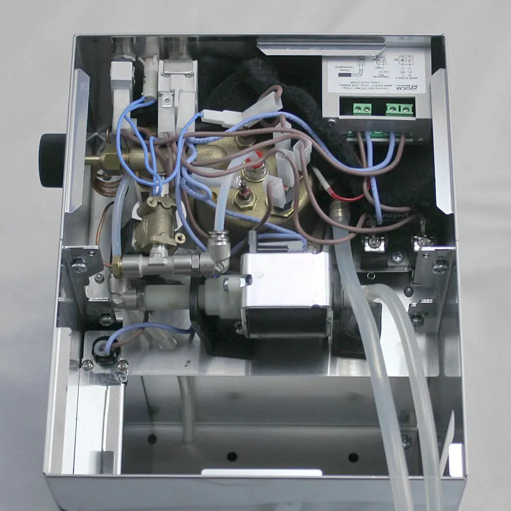 Inside view of a Lelit PL41 Anna coffee machine showing electrical wires, metal components, tubes, and a circuit board—perfect for understanding Solenoid Valve Repair and the internal mechanical and electronic parts. 2025 1st-line.com