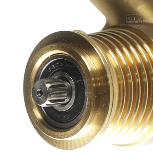 Close-up view of a brass worm gear with a visible spur gear and bearing at the center, showing fine details of the metal ridges and inner components. © 2025 1st-line.com