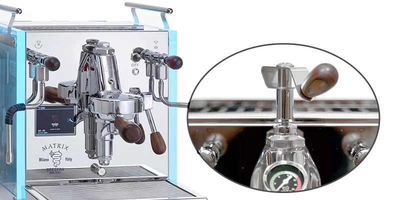 Close-up of a shiny stainless steel espresso machine with wood-accented handles and gauges. An inset shows a detailed view of the steam control lever and pressure gauge&mdash;perfect for those seeking package deals on espresso machines and grinders. &copy; 2025 1st-line.com