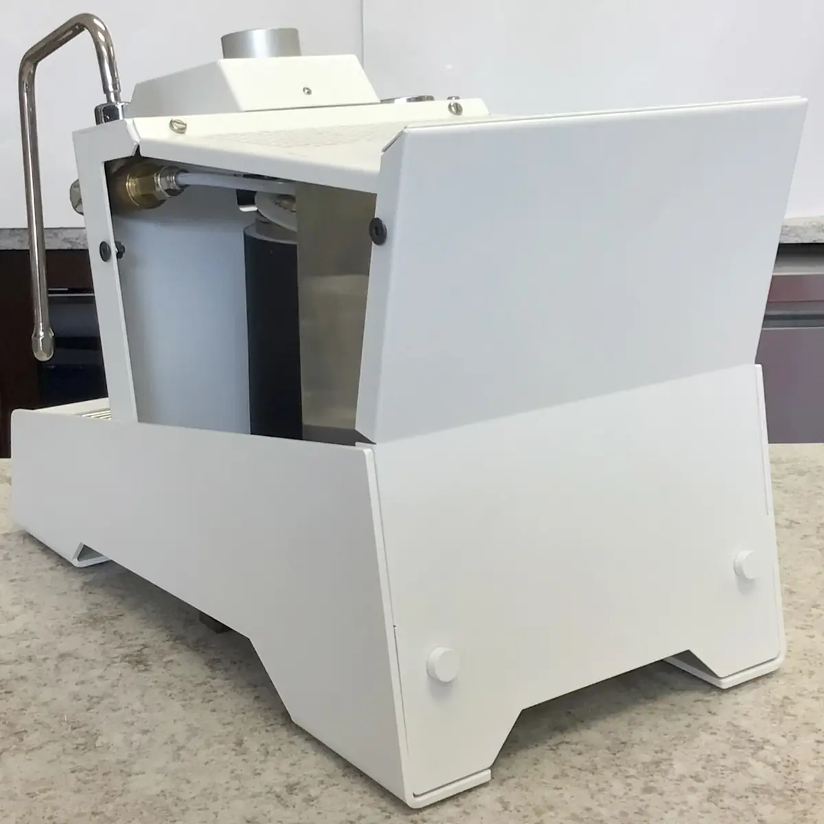 The SIDEWALK SALE Nurri R-TYPE SB (HX) Espresso Machine (RETURNED & REFURBISHED), featuring a white, boxy design with metal accents and a spout, rests on a speckled countertop against a neutral backdrop. 2025 1st-line.com