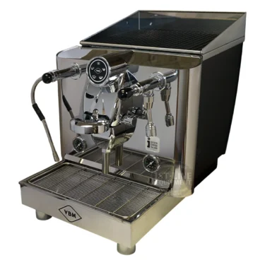 The VBM Lollo Electronic 1 Group HX Espresso Machine - 110V features dual gauges, a portafilter, steam wand, hot water spout, digital display, and sits on a drip tray with the VBM logo on the lower front panel.